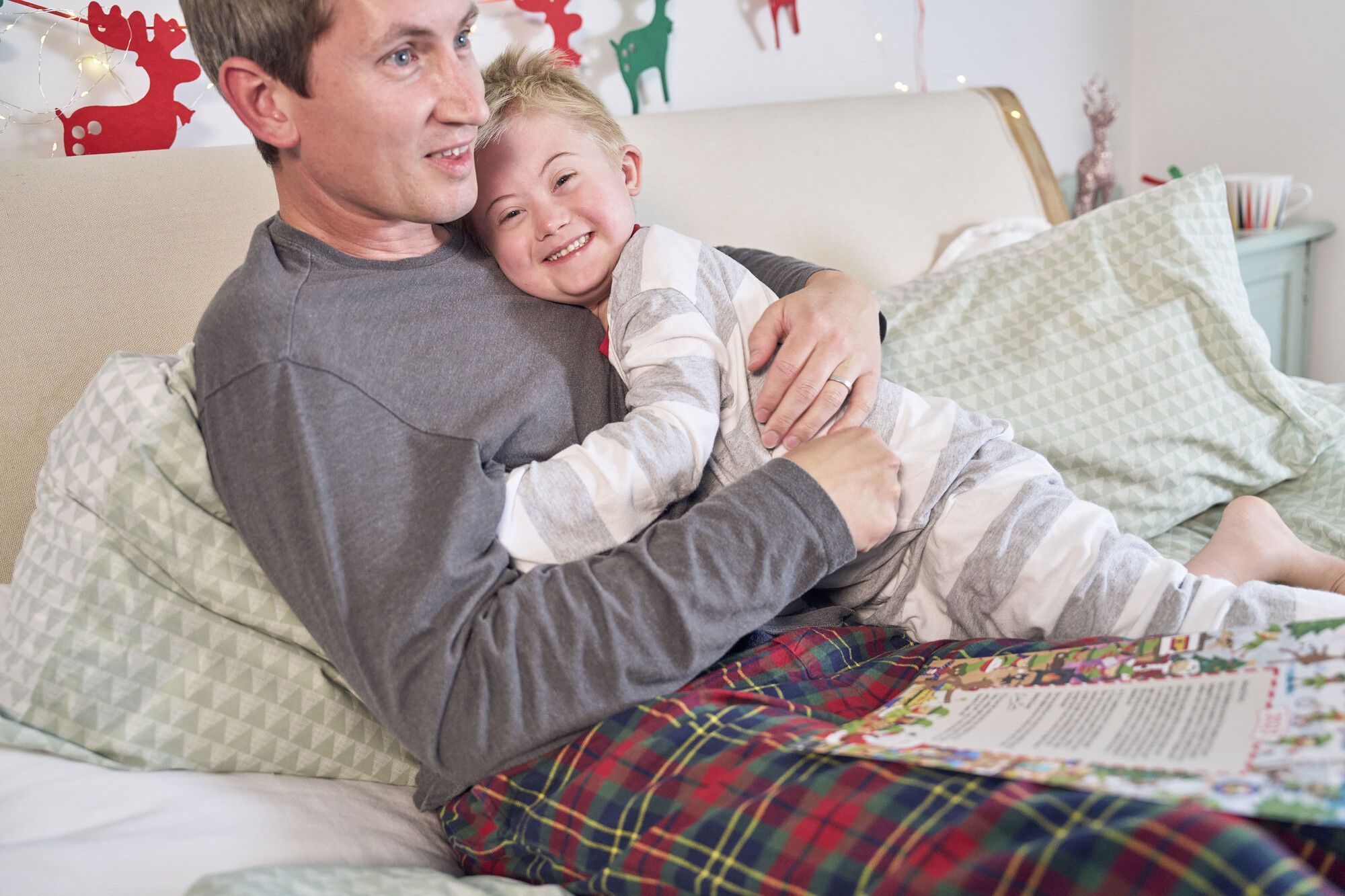 A child and his father share a hug at Christmas