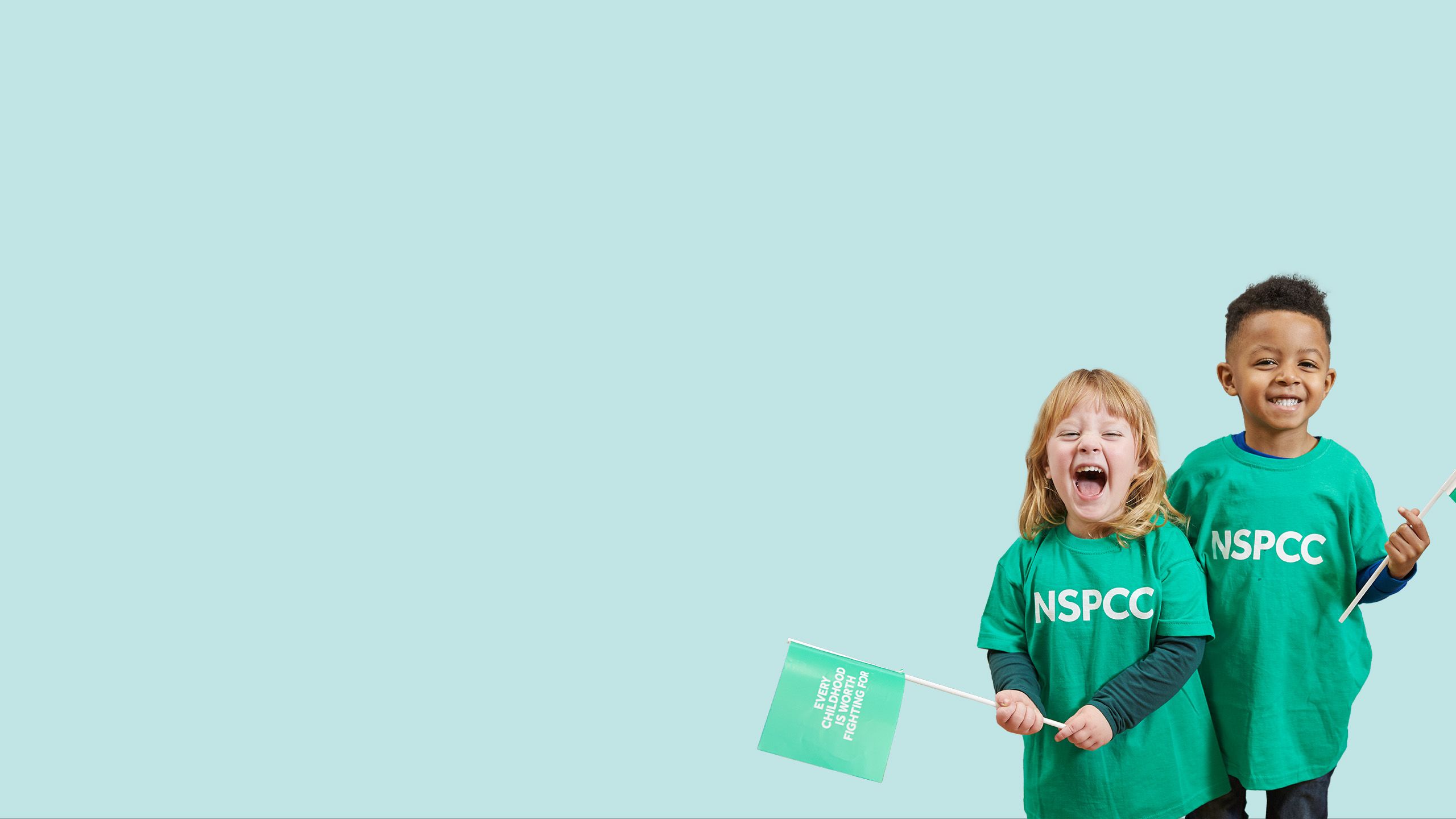 Two children wearing NSPCC tshirts and holding NSPCC flags
